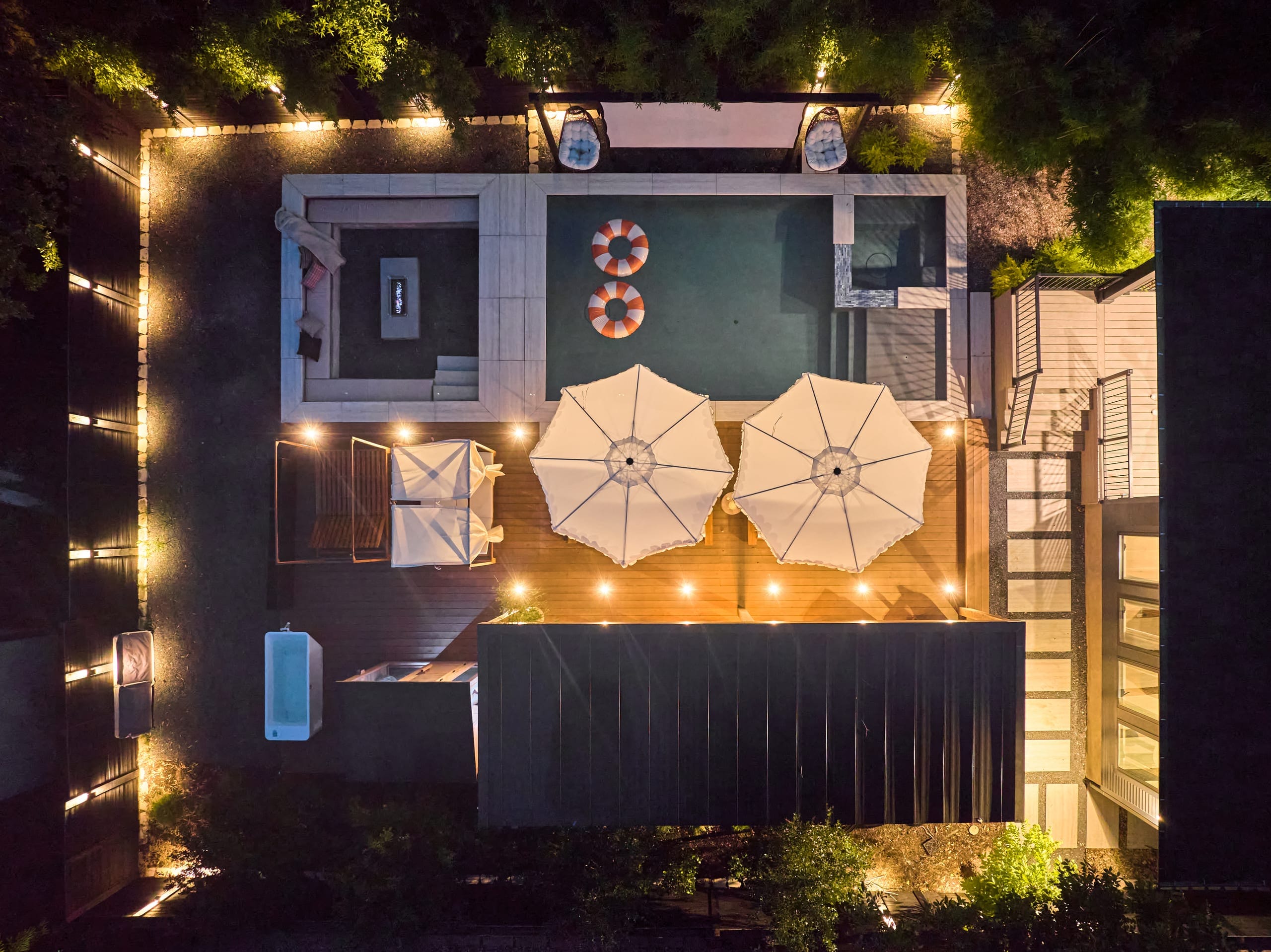 Aerial view of the backyard lit at night