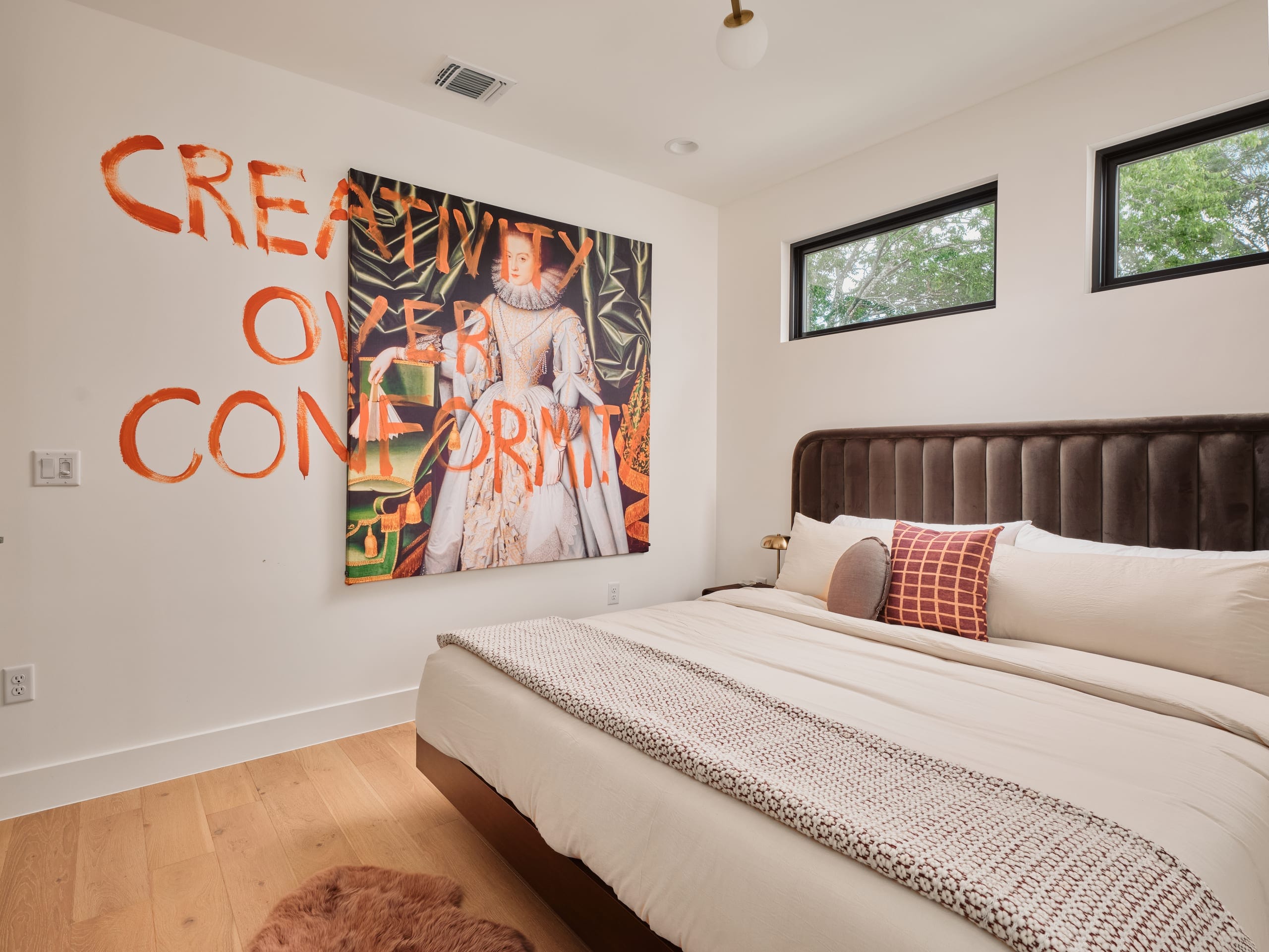 The Creator Room with a king bed beneath framed artwork